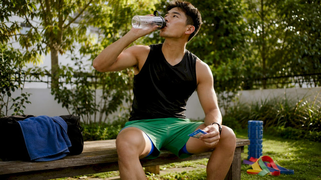 Athlete hydrating with electrolyte drink during workout