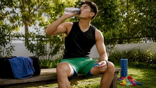 Athlete hydrating with electrolyte drink during workout