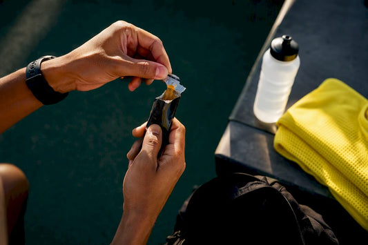 Runner taking energy gel before race