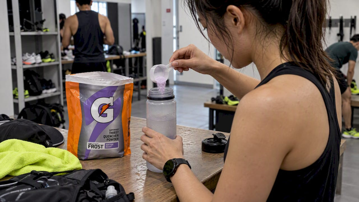 Athlete mixing Gatorade powder before training