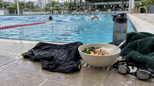 Swimmer eating a recovery meal poolside