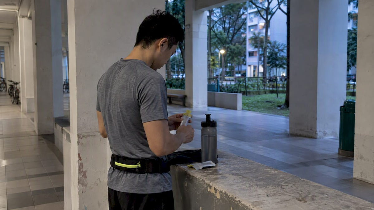 Runner checking fuel before an early race