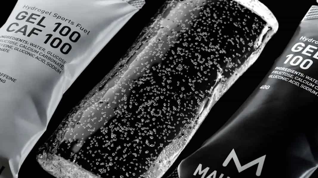 Close-up of a sports gel with visible branding and text on a black background